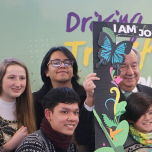 A picture of young people around the UN SG, at the youth summit before COP15
